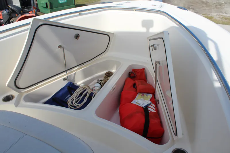 Slide: The Image of Open storage compartments on 2008 Pursuit C230 boat with ropes and red bag. - 23