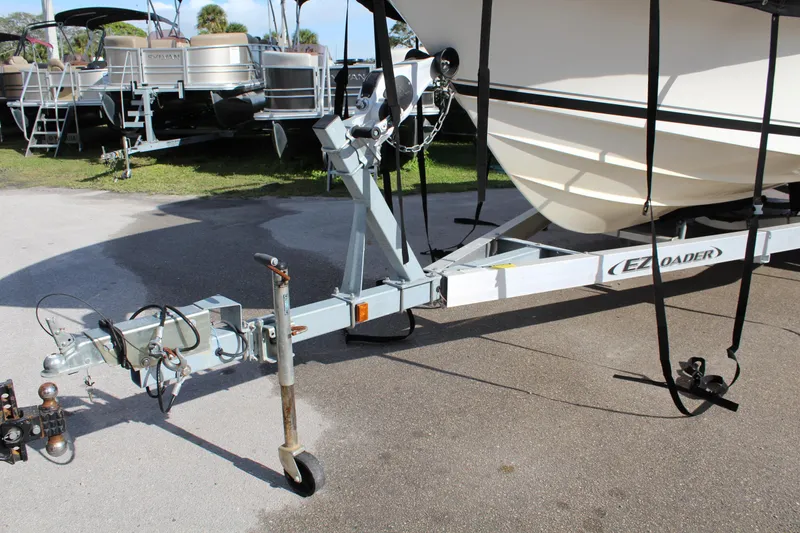 Slide: The Image of Boat trailer for 2008 Pursuit C230, parked outdoors on a sunny day. - 9