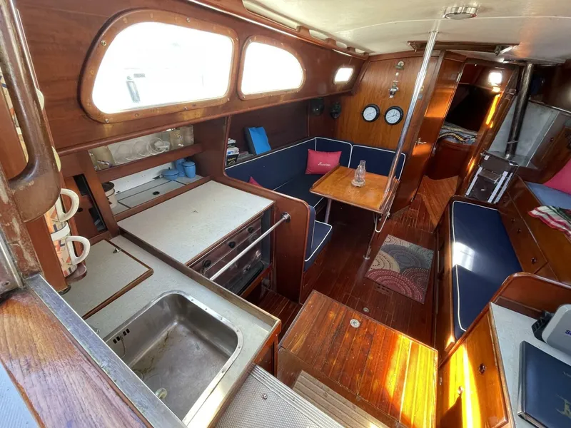 Slide: The Image of Interior of 1968 LeComte Northeast 38 sailboat with wood finish and cozy seating area. - 13