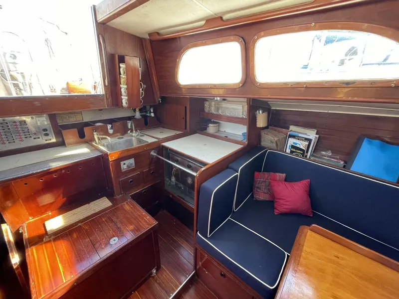 Slide: The Image of Interior of 1968 LeComte Northeast 38 sailboat with wood finish and cozy seating area. - 15