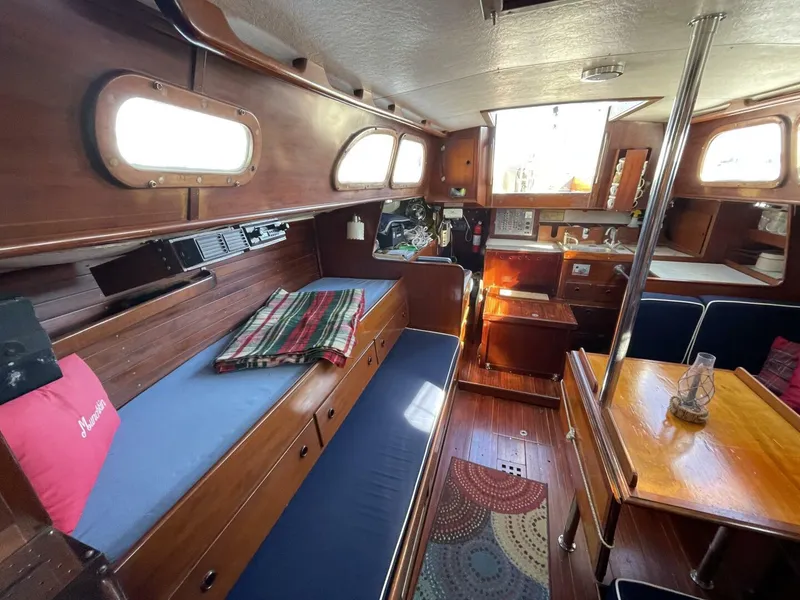 Slide: The Image of Interior of 1968 LeComte Northeast 38 sailboat with wooden furnishings and cozy seating. - 16