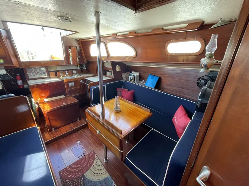 Slide: The Image of Interior of 1968 LeComte Northeast 38 sailboat with wooden furnishings and blue seating. - 17