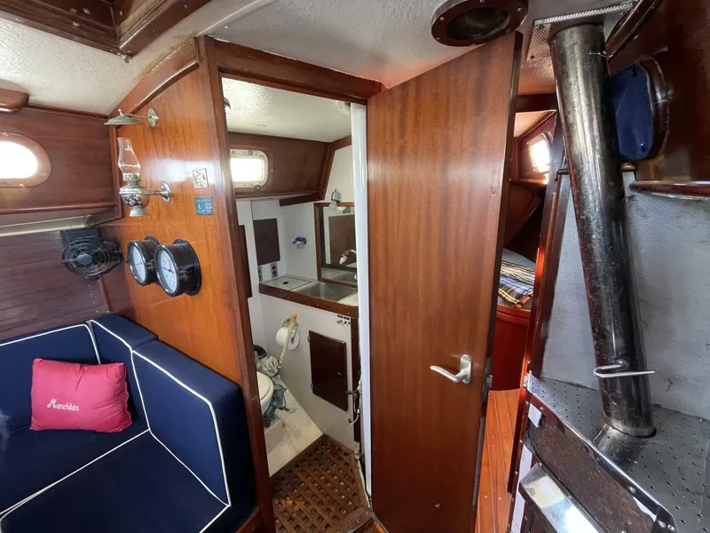 Slide: The Image of Interior of 1968 LeComte Northeast 38 sailboat with wood paneling and nautical decor. - 19