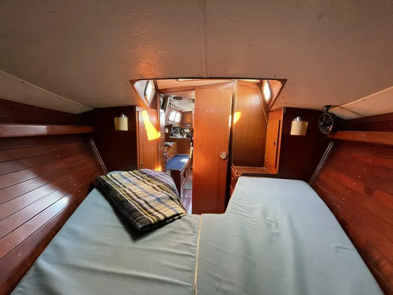 Slide: The Image of Interior cabin of 1968 LeComte Northeast 38 sailboat with twin beds and wooden paneling. - 21