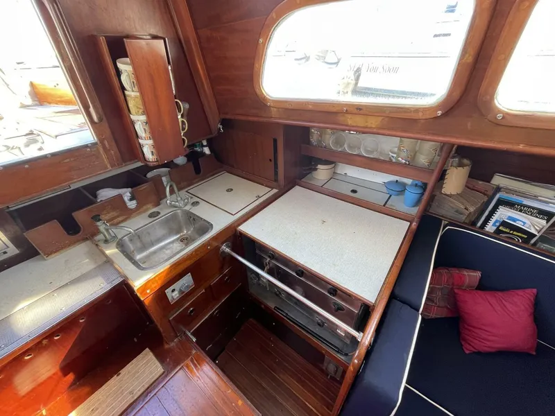 Slide: The Image of Interior of 1968 LeComte Northeast 38 sailboat with kitchen and seating area. - 23