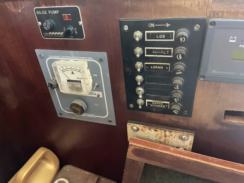 Slide: The Image of Control panel of a 1968 LeComte Northeast 38 sailboat with various switches and gauges. - 27