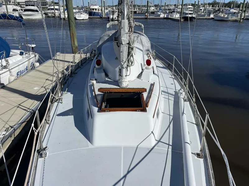 Slide: The Image of 1968 LeComte Northeast 38 sailboat docked at marina, view of deck and mast. - 3