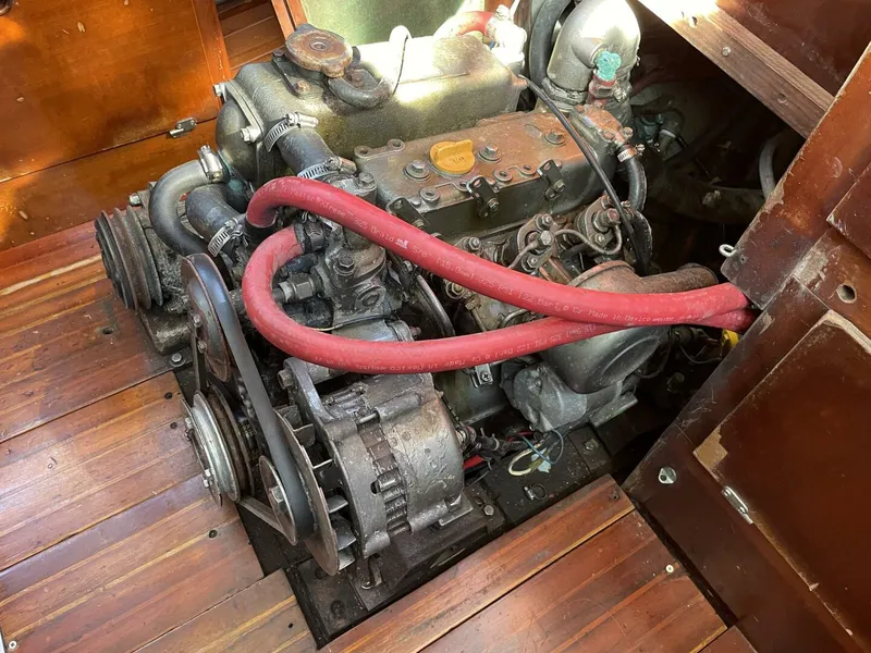 Slide: The Image of Engine of a 1968 LeComte Northeast 38 sailboat with red hoses and wooden flooring. - 30
