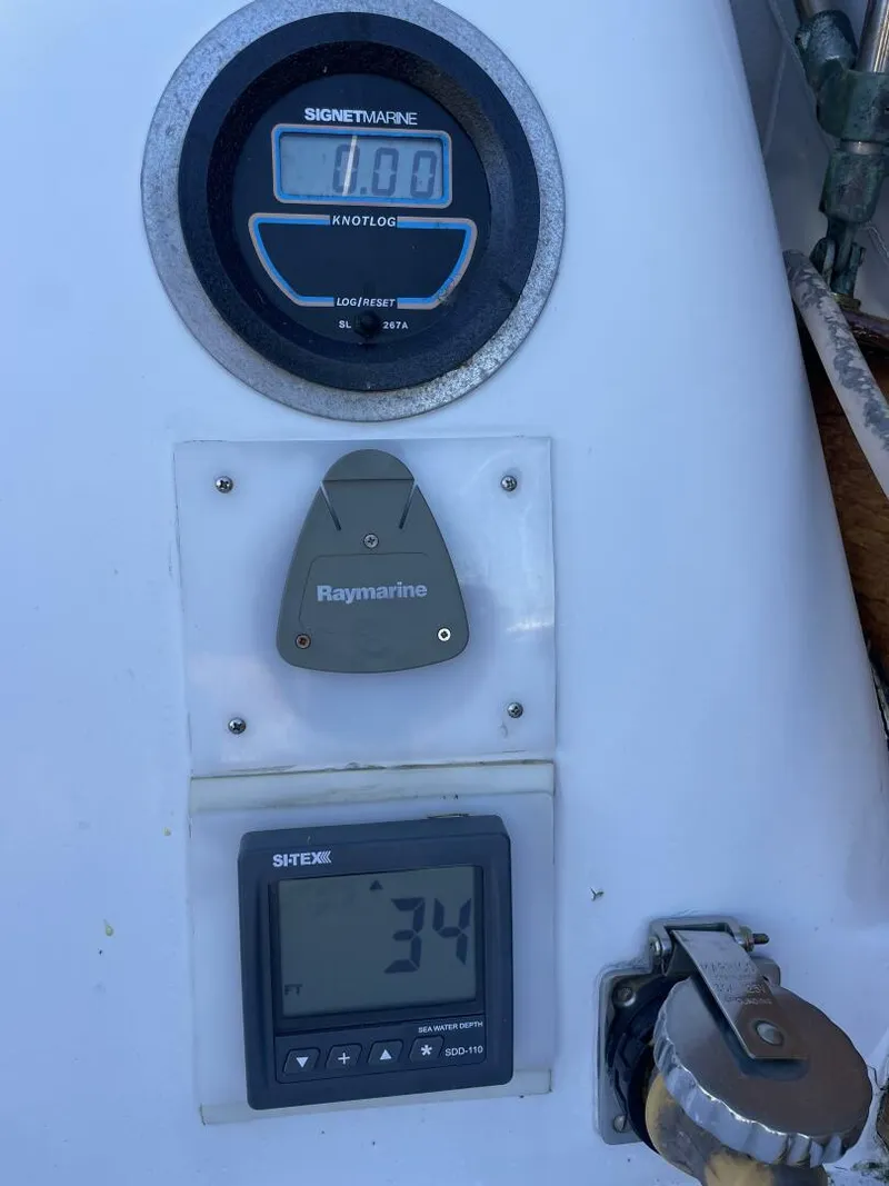 Slide: The Image of Instrument panel on a 1968 LeComte Northeast 38 sailboat, featuring marine gauges and controls. - 31