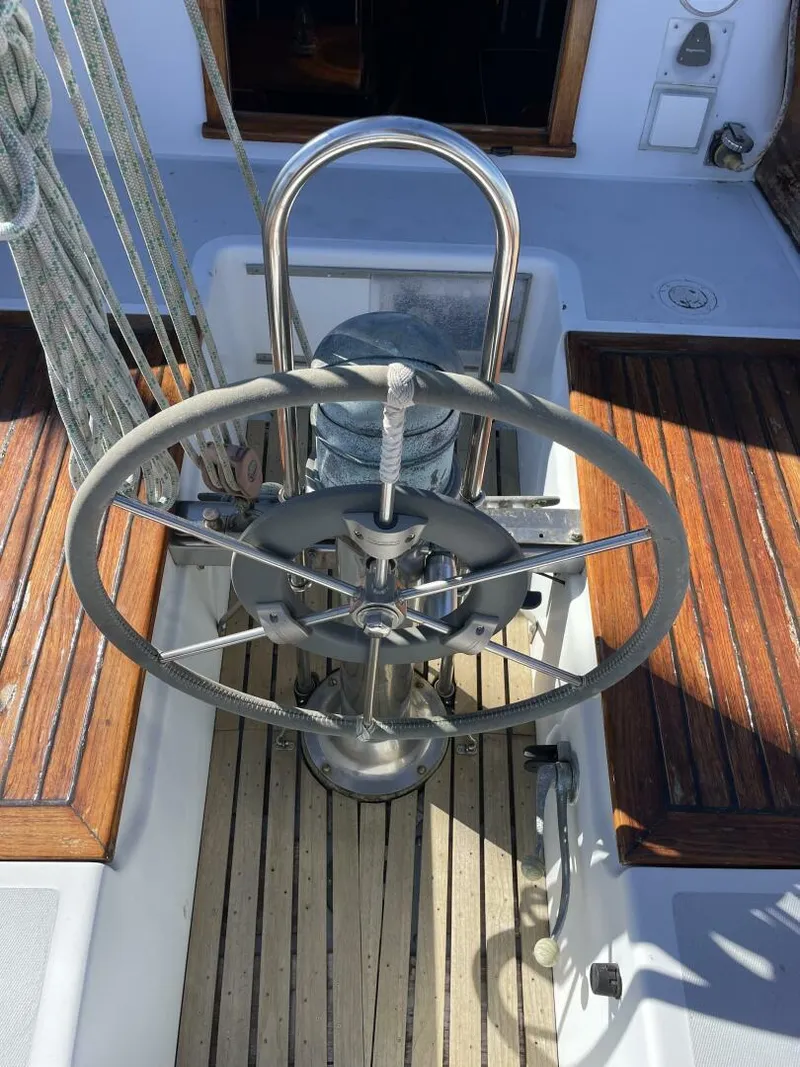 Slide: The Image of 1968 LeComte Northeast 38 sailboat helm with wooden deck and stainless steel wheel. - 33
