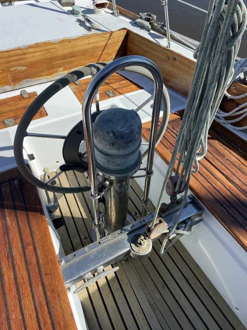 Slide: The Image of 1968 LeComte Northeast 38 sailboat cockpit with wooden deck and steering wheel. - 34
