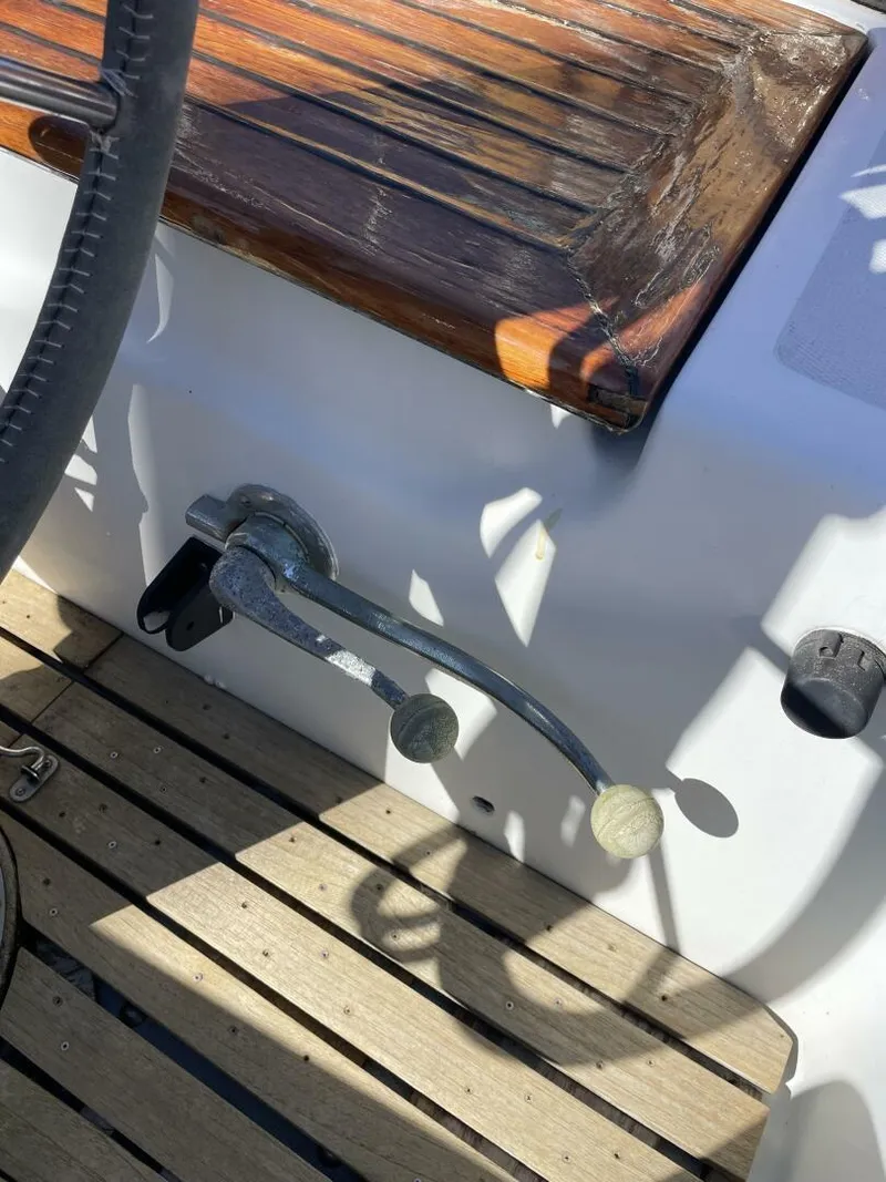 Slide: The Image of 1968 LeComte Northeast 38 boat cockpit with wooden bench and control lever. - 35