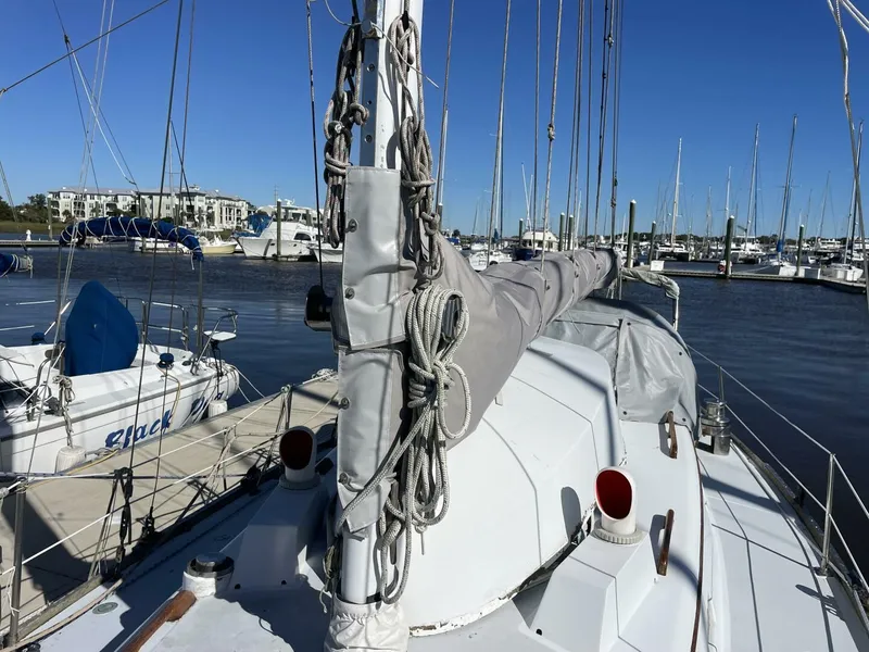 Slide: The Image of 1968 LeComte Northeast 38 sailboat docked at marina under clear blue sky. - 39