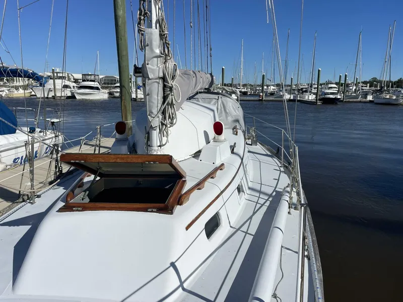 Slide: The Image of 1968 LeComte Northeast 38 sailboat docked in a marina, clear blue sky. - 4