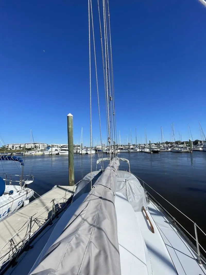 Slide: The Image of 1968 LeComte Northeast 38 sailboat docked at marina under clear blue sky. - 40