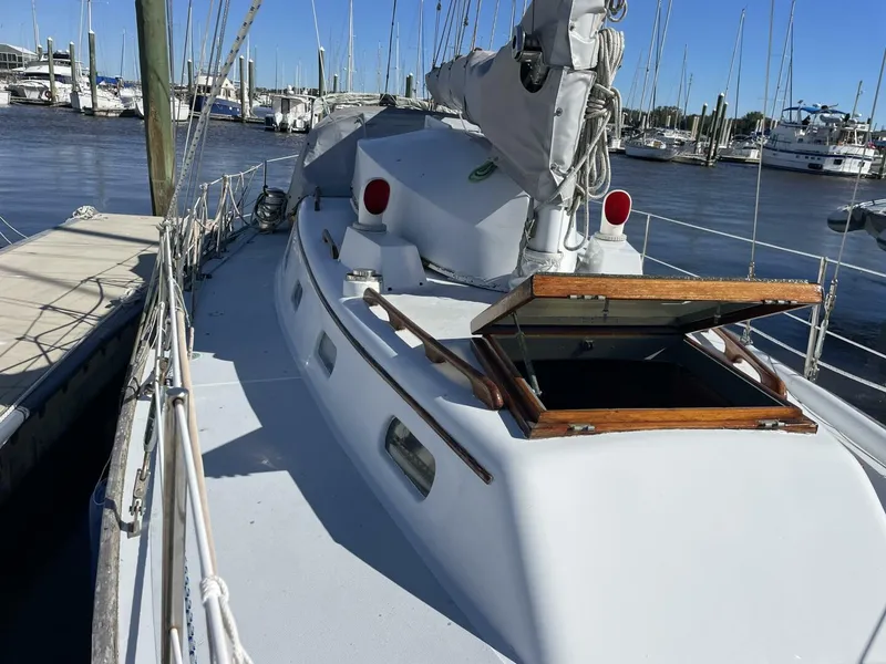 Slide: The Image of 1968 LeComte Northeast 38 sailboat docked at marina under clear blue sky. - 5