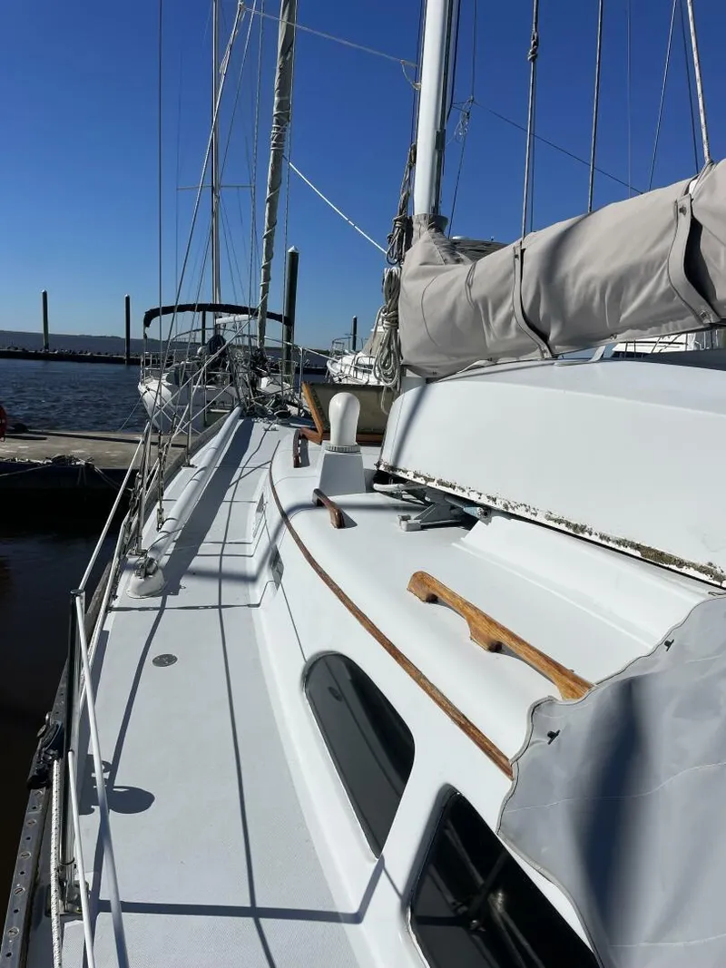 Slide: The Image of 1968 LeComte Northeast 38 sailboat docked at marina under clear blue sky. - 6