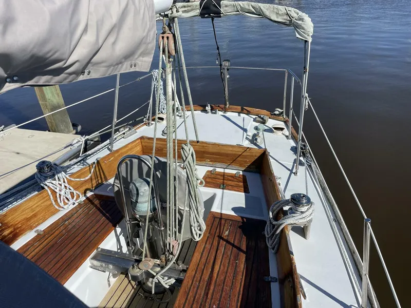 Slide: The Image of 1968 LeComte Northeast 38 sailboat with wooden deck and rigging, docked by calm water. - 7