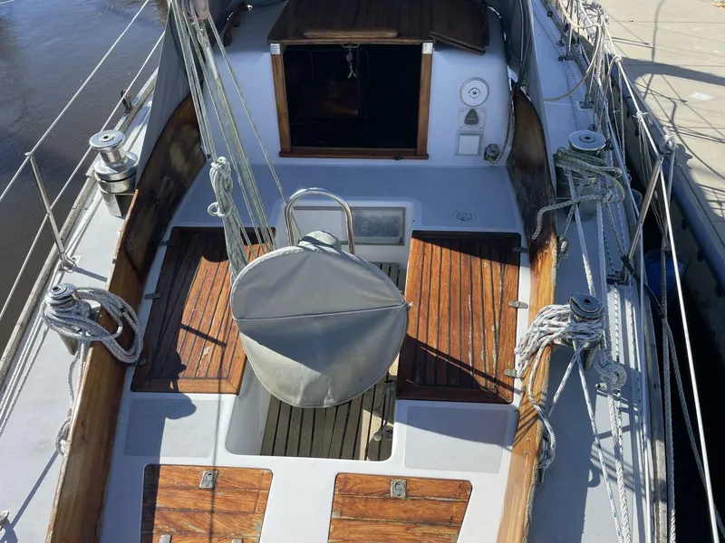 Slide: The Image of 1968 LeComte Northeast 38 sailboat cockpit with wooden deck and rigging. - 8