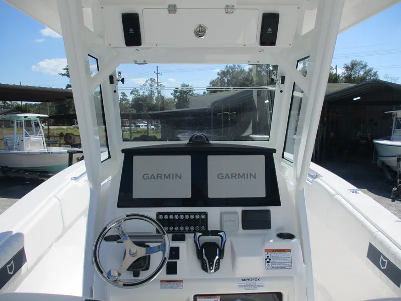 Slide: The Image of 2025 Sea Fox 288 Commander boat dashboard with Garmin navigation displays. - 6
