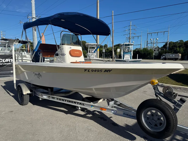 Slide: The Image of 2006 NauticStar 1800 Nautic Bay boat on trailer with blue canopy. - 12