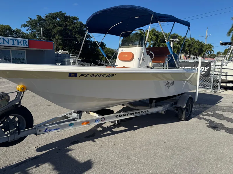 Slide: The Image of 2006 NauticStar 1800 Nautic Bay boat on trailer with blue canopy in sunny setting. - 13