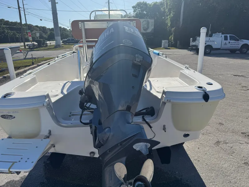 Slide: The Image of 2006 NauticStar 1800 Nautic Bay boat with outboard motor, parked outdoors. - 3