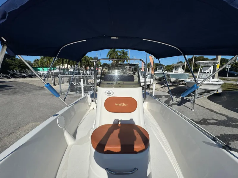 Slide: The Image of 2006 NauticStar 1800 Nautic Bay boat with canopy, parked outdoors. - 9