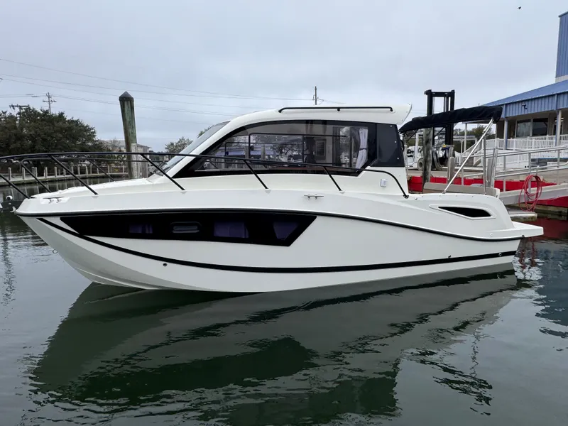 Slide: The Image of 2025 Trophy T25 Explorer boat docked in marina, side view. - 1