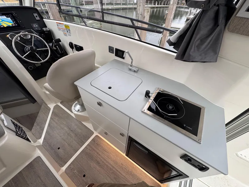 Slide: The Image of 2025 Trophy T25 Explorer boat interior with helm, sink, and stove. - 11