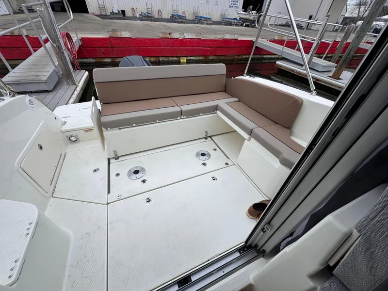 Slide: The Image of 2025 Trophy T25 Explorer boat interior with beige seating and spacious deck area. - 13
