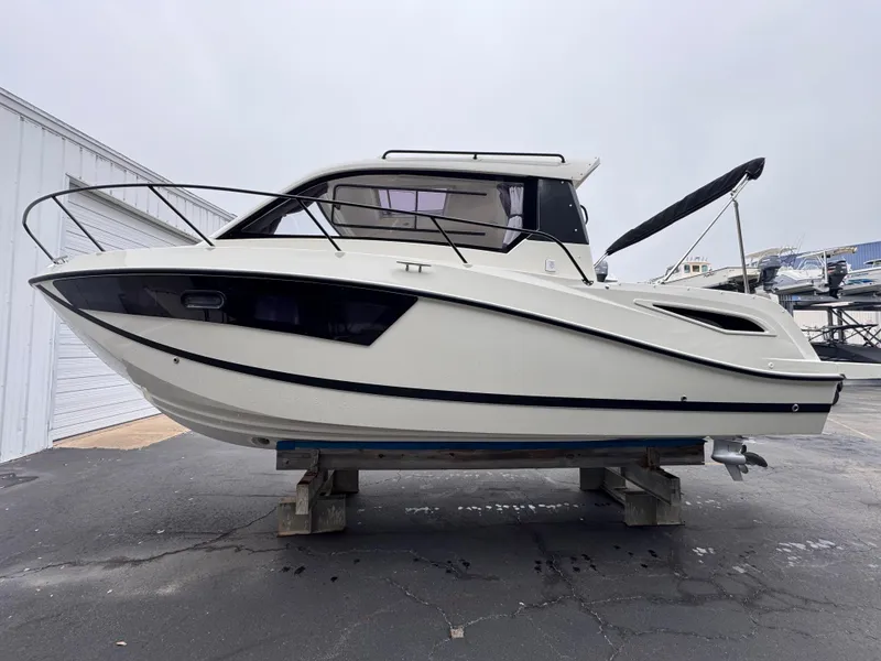 Slide: The Image of 2025 Trophy T25 Explorer boat on display, side view, in a marina setting. - 16
