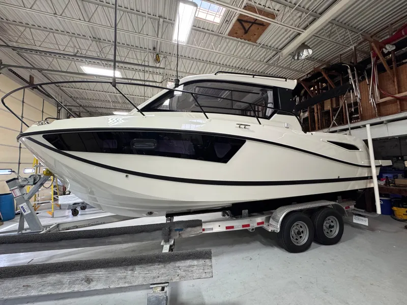 Slide: The Image of 2025 Trophy T25 Explorer boat on trailer in indoor storage. - 2