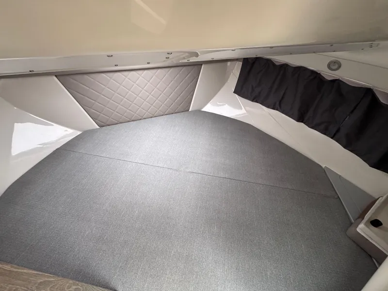 Slide: The Image of Interior cabin of 2025 Trophy T25 Explorer boat with cushioned seating and curtains. - 6