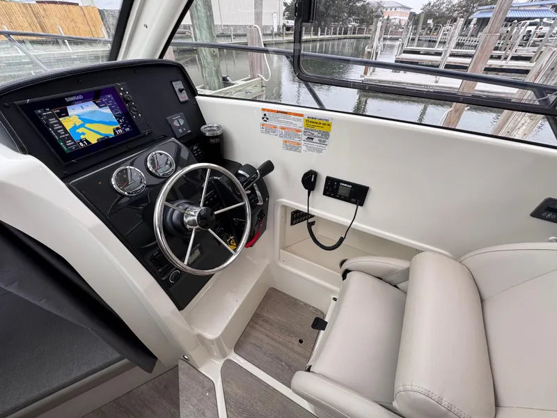 Slide: The Image of 2025 Trophy T25 Explorer boat cockpit with steering wheel and navigation display. - 9
