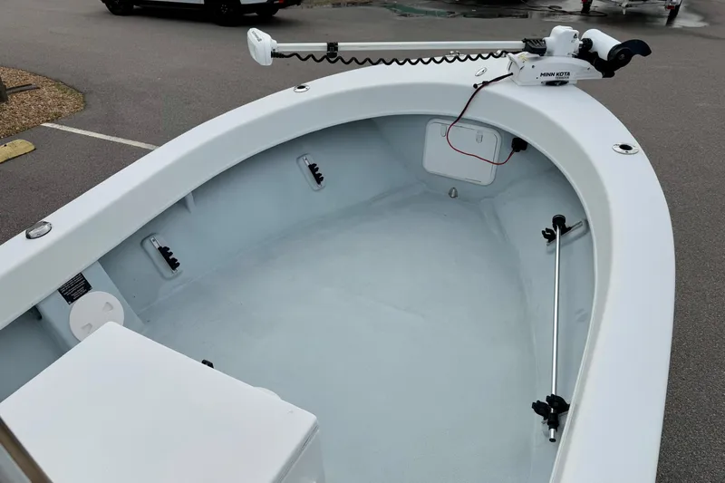 Slide: The Image of 2020 Privateer 1800 Retriever boat interior with trolling motor, parked on pavement. - 10