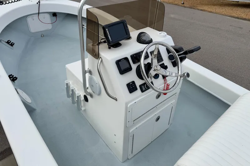Slide: The Image of 2020 Privateer 1800 Retriever boat console with steering wheel and navigation equipment. - 18