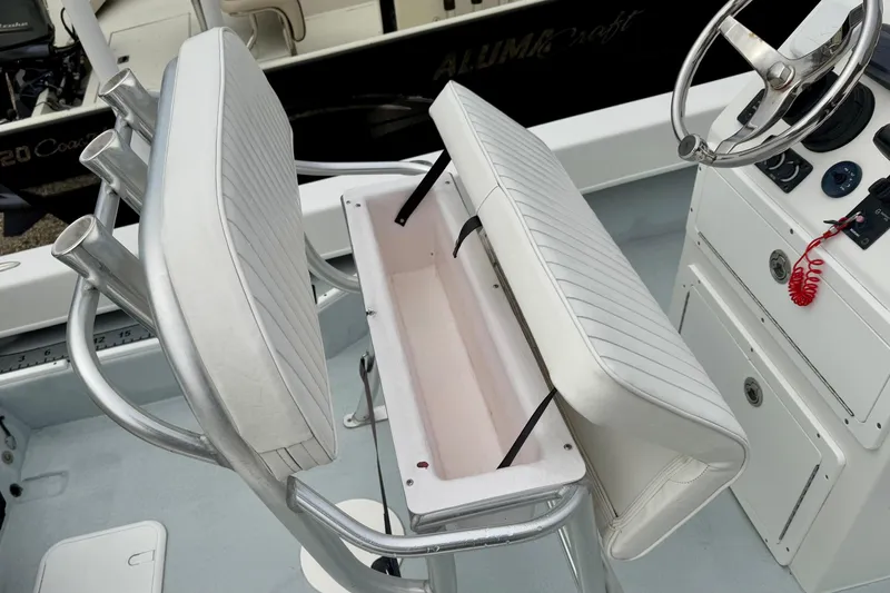 Slide: The Image of Privateer 1800 Retriever 2020 boat interior with white cushioned seating and steering console. - 23