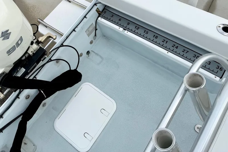 Slide: The Image of Privateer 1800 Retriever 2020 boat deck with Suzuki 90 engine and measuring ruler. - 26