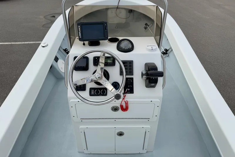 Slide: The Image of 2020 Privateer 1800 Retriever boat console with steering wheel and navigation equipment. - 3