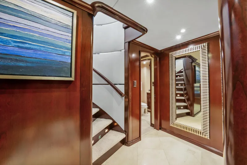 Slide: The Image of Luxurious interior of 2005 Trinity Yachts Tri-Deck with elegant wood paneling and staircase. - 17