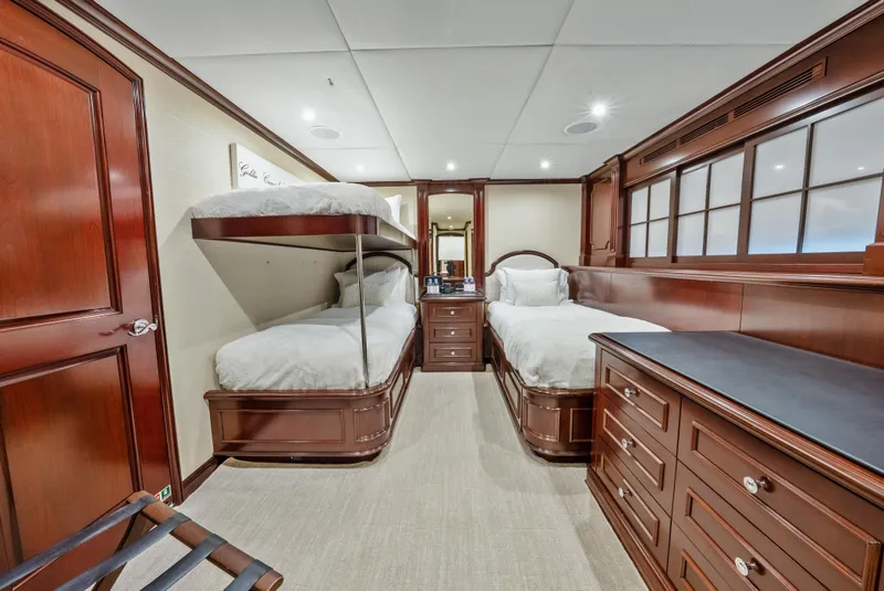 Slide: The Image of Luxurious 2005 Trinity Yachts Tri-Deck cabin with elegant wood furnishings and twin beds. - 18