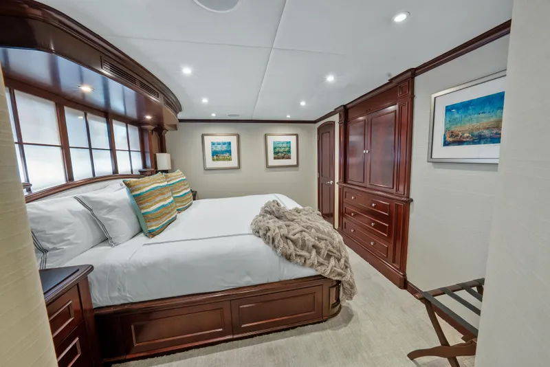 Slide: The Image of Luxurious bedroom in 2005 Trinity Yachts Tri-Deck with elegant wood furnishings. - 24