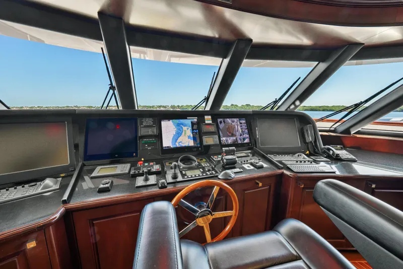 Slide: The Image of Bridge of 2005 Trinity Yachts Tri-Deck, featuring navigation equipment and leather seating. - 34