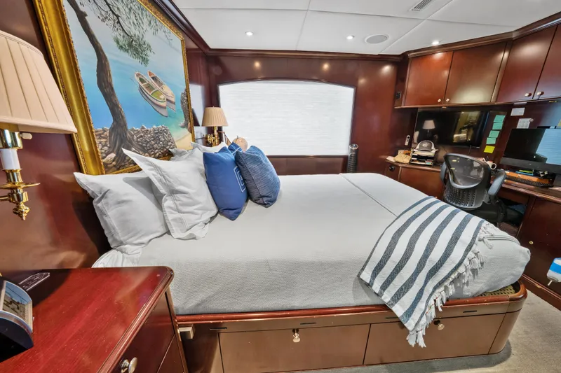 Slide: The Image of Luxurious bedroom interior on 2005 Trinity Yachts Tri-Deck, featuring elegant wood finishes and cozy bedding. - 36