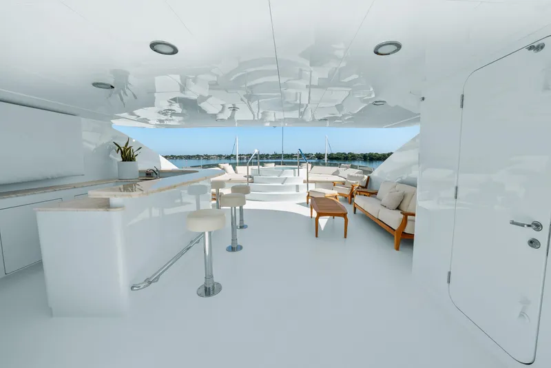 Slide: The Image of Luxurious 2005 Trinity Yachts Tri-Deck interior with modern seating and bar area. - 48