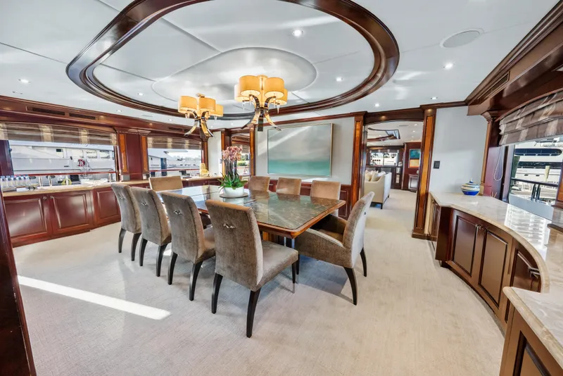 Slide: The Image of Luxurious dining area on 2005 Trinity Yachts Tri-Deck, featuring elegant wood finishes and plush seating. - 5