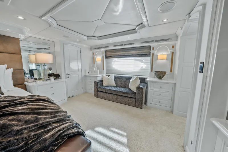 Slide: The Image of Luxurious bedroom interior on 2005 Trinity Yachts Tri-Deck, featuring elegant furnishings and soft lighting. - 11