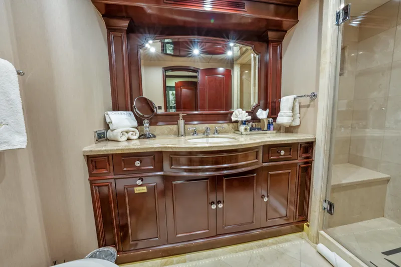Slide: The Image of Luxurious bathroom vanity on 2005 Trinity Yachts Tri-Deck, featuring elegant wood cabinetry and large mirror. - 20