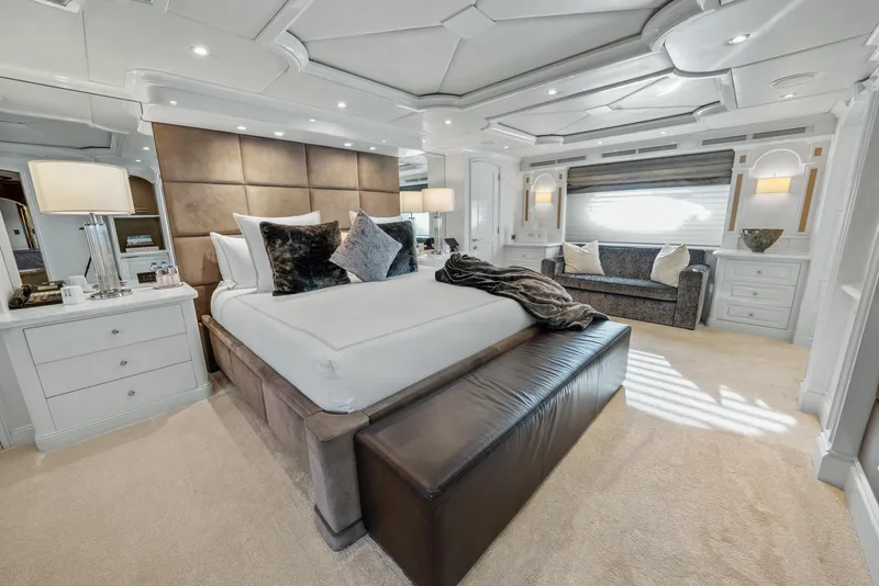 Slide: The Image of Luxurious bedroom interior on 2005 Trinity Yachts Tri-Deck, featuring elegant furnishings and ambient lighting. - 9